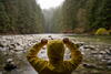 a person standing next to a river bank